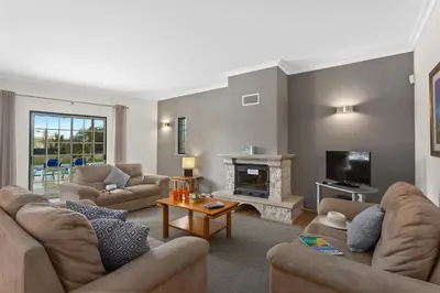 a living room with couches and a fireplace at Villa João Paulo in Albufeira