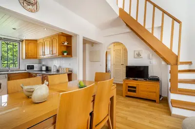a kitchen and dining room with a wooden table and chairs at Vilamoura Oasis Family Duplex in Vilamoura
