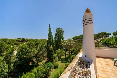 a lighthouse on top of a building with a garden at Vilamoura Oasis Family Duplex in Vilamoura