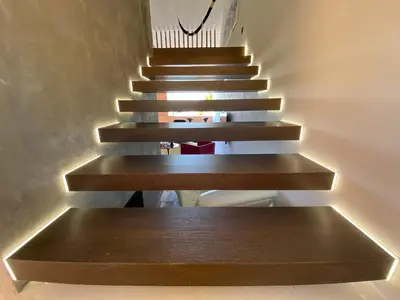 a staircase with wooden steps with a stair light on it at Vilamoura Marina Mezzanine Loft in Vilamoura