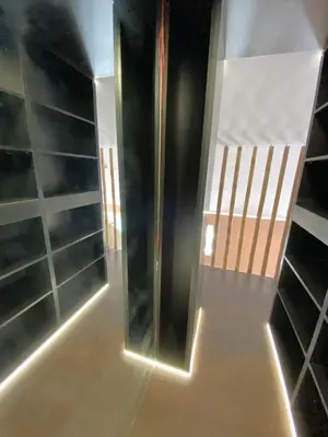 a walk in shower in a room with shelves at Vilamoura Marina Mezzanine Loft in Vilamoura