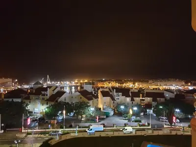 a view of a city at sunset from a building at Marina Mar Vilamoura Apartment in Vilamoura