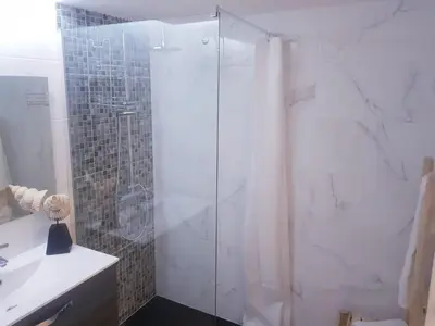 a shower with a glass door in a bathroom at Marina Mar Vilamoura Apartment in Vilamoura