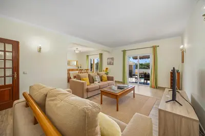 a living room with a couch and a tv at Villa Monte Velho in Albufeira