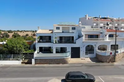 a villa with a swimming pool in front of a house at Villa Tropicana in Albufeira