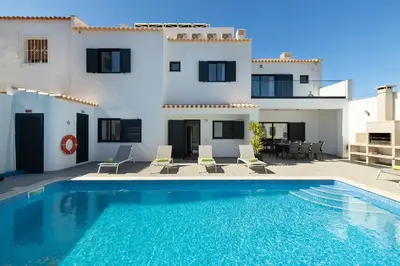 a living room with a couch and a table at Villa Tropicana in Albufeira