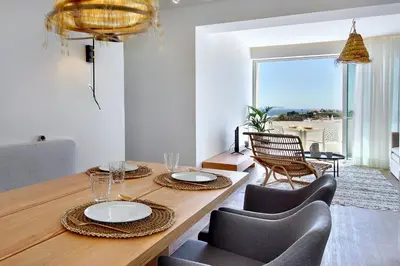 a dining room with a table and chairs with a view at Apartamento Boavista - Sea View by DreamvillasAlbufeira in Albufeira