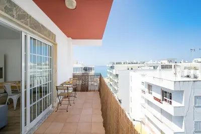 a balcony with chairs and a view of the ocean at AL - Apartamento Vidal Mar in Quarteira