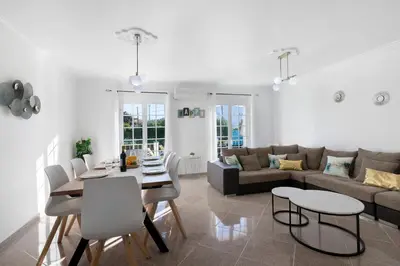 a kitchen with a sink and a white refrigerator at Villa Sunshine in Roja- Pé