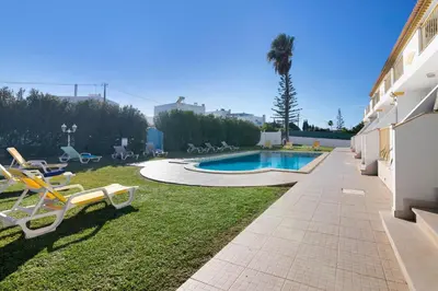 a large white building with a lawn in front of it at Villa Sunshine in Roja- Pé