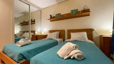 a bedroom with two beds with towels on them at T2 Apartment Falesia Beach Albufeira in Roja- Pé