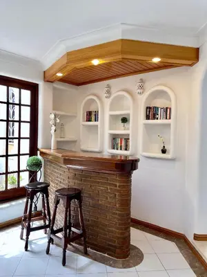 a bar in a room with two stools at Villa Cristina 9 in Albufeira