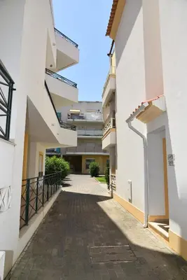 an empty alley between two buildings at Sandy Beach apartment in Albufeira