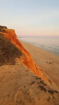 a group of people standing on a sandy beach at Sandy Beach apartment in Albufeira