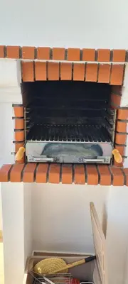 a stack of books sitting on top of an oven at Sandy Beach apartment in Albufeira