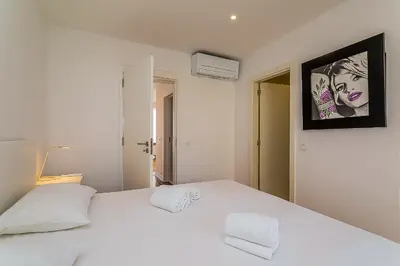 a bedroom with a large white bed with two white pillows at Vista dos Seus Sonhos T2 HsR Vilamarina in Vilamoura