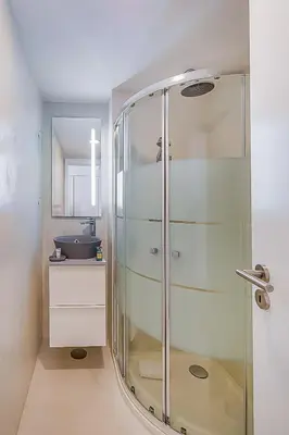 a glass shower in a bathroom with a sink at Vista dos Seus Sonhos T2 HsR Vilamarina in Vilamoura