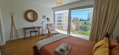 a bedroom with a bed and a large window at Villa Ray Design in Albufeira