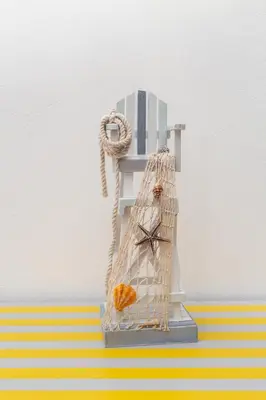 a toy clock sitting on top of a shelf at Casa da Praia dos Pescadores in Albufeira