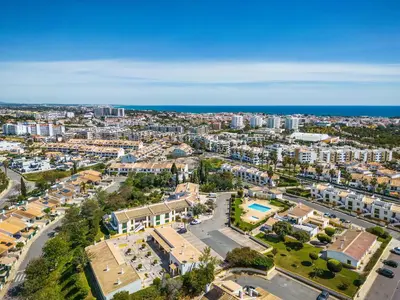 an aerial view of a city with buildings and the ocean at Nuances do Oceano by OCvillas in Albufeira