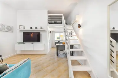 a room with a loft bed and a tv at Nuances do Oceano by OCvillas in Albufeira