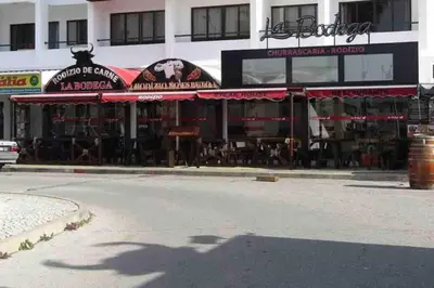 a restaurant on a street in front of a building at Vacations home Albufeira in Albufeira