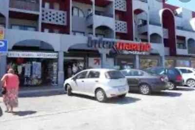 a group of cars parked in front of a building at Vacations home Albufeira in Albufeira