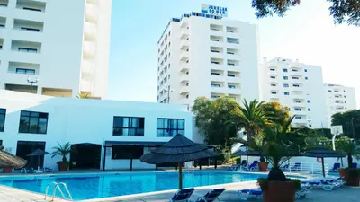a swimming pool in the middle of some buildings at Albufeira 603 in Albufeira