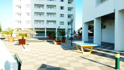 a patio with a bench and a building at Albufeira 603 in Albufeira