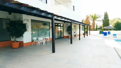a building with a patio with tables and chairs at Albufeira 603 in Albufeira