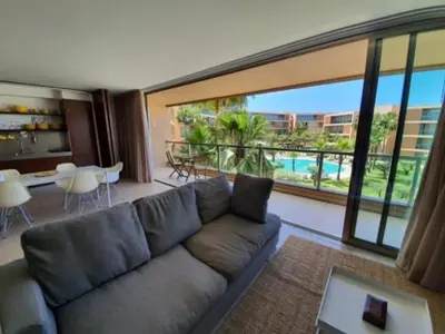a living room with a couch and a large window at Ambassador Salgados Beach Suites in Albufeira