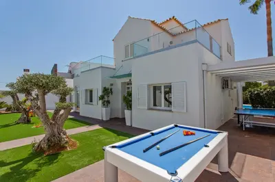 a pool table in front of a house at Villa Maresia Dourada in Guia