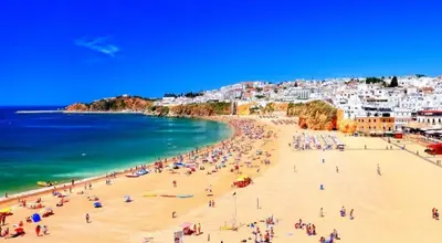 a group of people on a beach near the water at 125 Oliveiras Terraces in Albufeira