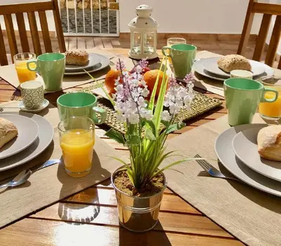 a table with plates and glasses of orange juice at 125 Oliveiras Terraces in Albufeira