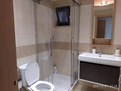 a bathroom with a shower and a toilet and a sink at Cozy villa with pool and Barbecue in Albufeira