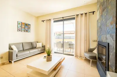 a living room with a couch and a tv at Cozy villa with pool and Barbecue in Albufeira