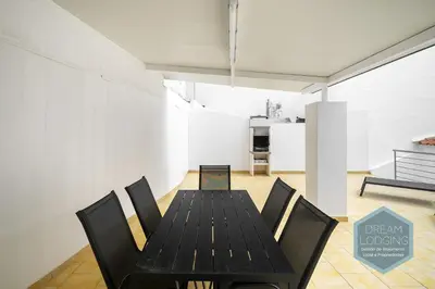 a dining room with a black table and chairs at Old Town - Albufeira - Dream Lodging in Albufeira