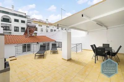 a patio with a table and chairs on a roof at Old Town - Albufeira - Dream Lodging in Albufeira