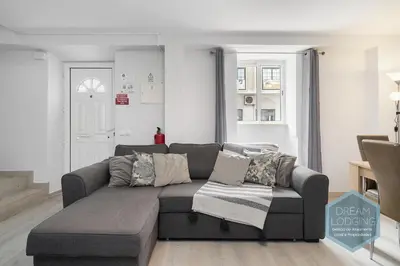 a living room with a gray couch in a room at Old Town - Albufeira - Dream Lodging in Albufeira