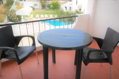 a blue table and two chairs on a balcony at Apartamentos Pedro for Families by Bedzy in Albufeira