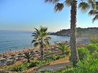 a group of people on a beach with the ocean at V4, Villa Jardins Branqueira near Beach, Albufeira in Albufeira