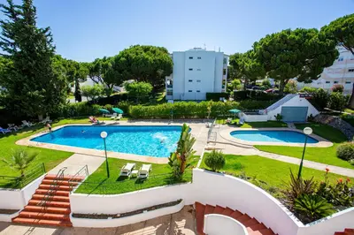 a view of a swimming pool in a resort at Host Wise - Bright Cozy Flats w Terrace & Pool in Quarteira