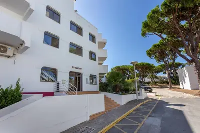 a white building with a staircase outside of it at Host Wise - Bright Cozy Flats w Terrace & Pool in Quarteira