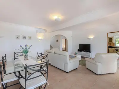 a living room with two white couches and a tv at Villa Villa Monte da Torre by Interhome in Loulé