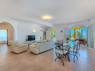 a living room with white furniture and a table at Villa Villa Monte da Torre by Interhome in Loulé