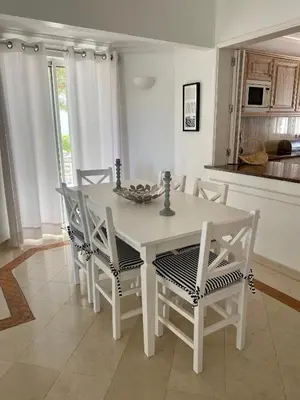 a white table and chairs in a kitchen at Beautiful apartment for rent in Quinta do Lago with excellent resort facilities close to lake and beach. in Quinta do Lago