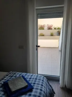 a bedroom with a bed and a sliding glass door at 