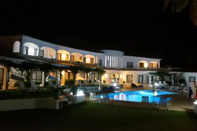 a large building with a swimming pool at night at FLOR DO VALE - APARTAMENTOS TURISTICOS in Guia