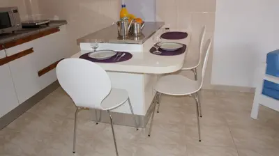 a white table and chairs in a kitchen at FLOR DO VALE - APARTAMENTOS TURISTICOS in Guia