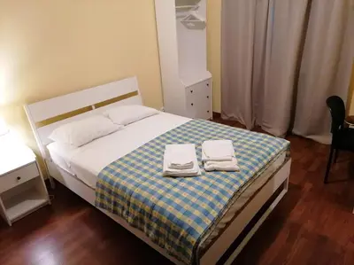 a bedroom with a bed with two towels on it at Minha casa in Faro